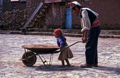 Side view of two people on road