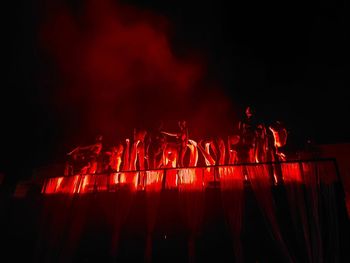 Low angle view of firework display at night