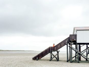 Lifeguard hut on beach against sky