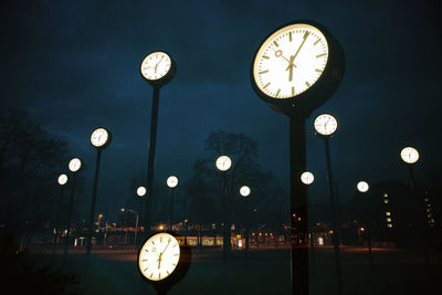 Low angle view of clock at night