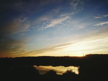 Scenic view of silhouette trees against sky at sunset