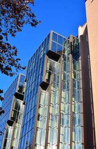 Low angle view of modern building against clear blue sky