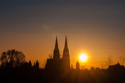 Silhouette of temple building against sky during sunset