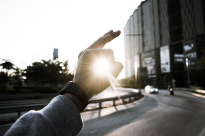 Cropped image of hand holding road