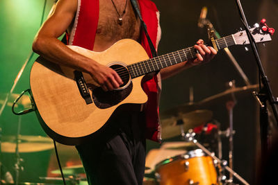 People playing guitar at music concert