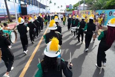 Rear view of musicians from a cultural group parading at fuzue, pre-carnival