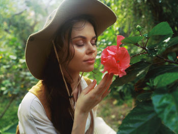 Close-up of young woman holding yellow flower