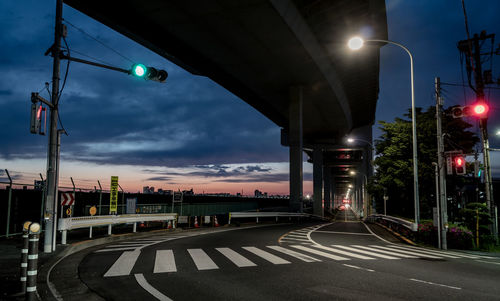 Illuminated street lights in city at night