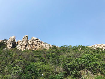 Scenic view of rocky mountains against clear blue sky