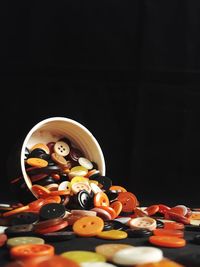 Close-up of toys on table against black background