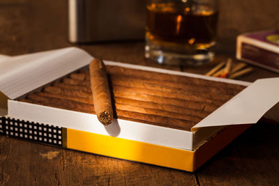 Close-up of cigars on wooden table