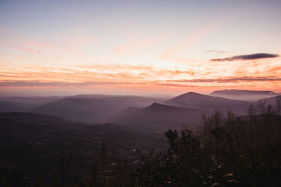 Scenic view of mountains against sky during sunset