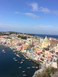 High angle view of townscape by sea against sky