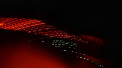 Low angle view of illuminated lighting equipment against sky at night