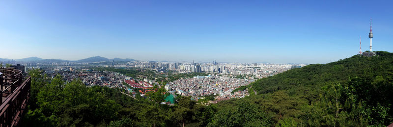 High angle view of buildings against clear blue sky
