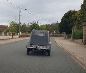 Car on street in city against sky