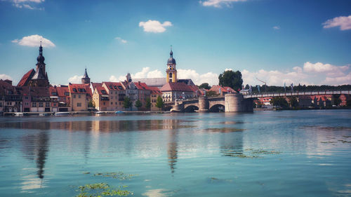 Bridge over river with buildings in background