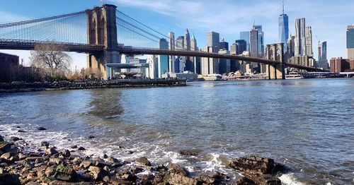 View of suspension bridge with city in background