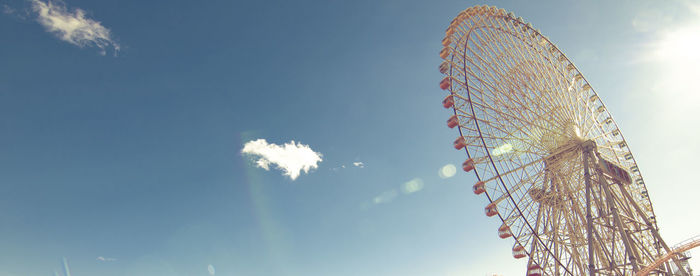 Low angle view of ferris wheel against sky