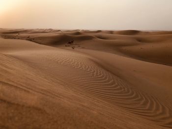 Sand dune in desert against sky