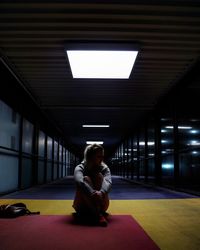 Full length of woman sitting in tunnel