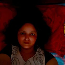 Portrait of cute girl lying on bed