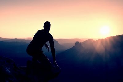 Silhouette man against mountains during sunset