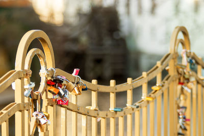 Love locks hanging on a metal fence by the river