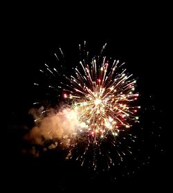 Low angle view of firework display against sky at night