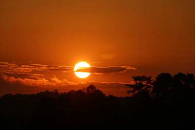 Scenic view of silhouette landscape against orange sky