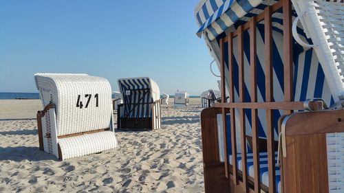 Hooded beach chairs on sandy beach