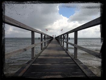 Pier over sea against sky