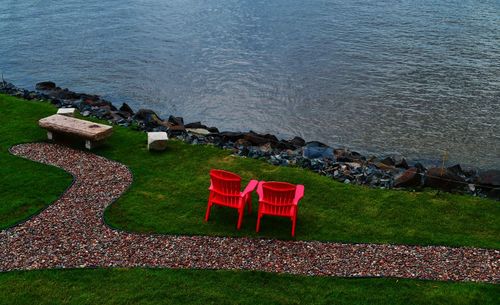 High angle view of chairs on rocks by sea