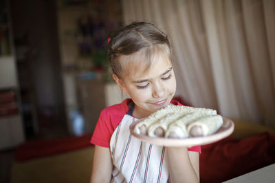 Girl holding ice cream at home