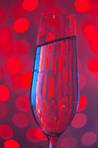 Close-up of champagne against red light