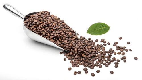 High angle view of coffee beans against white background