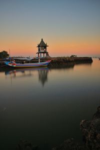 Scenic view of lake against sky during sunset