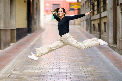 Portrait of young woman walking on street