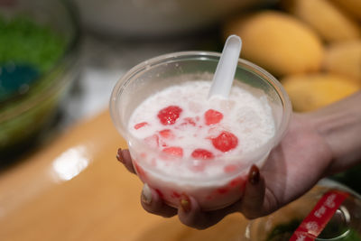 Close-up of hand holding ice cream