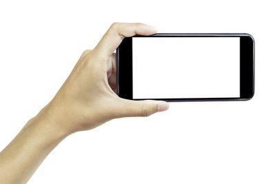 Low angle view of hand using mobile phone against white background