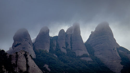 Low angle view of rocks against sky