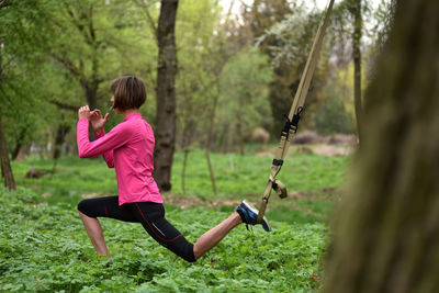 Mid adult woman exercising at public park