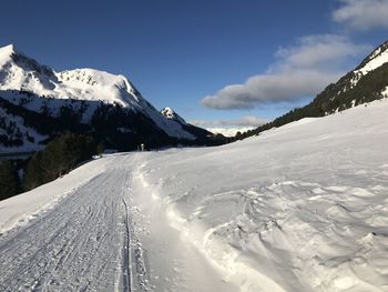 Scenic view of snow covered mountains against sky