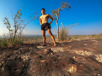 Full length of man standing on field against sky