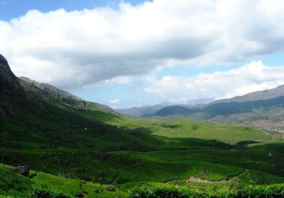 Scenic view of mountains against cloudy sky