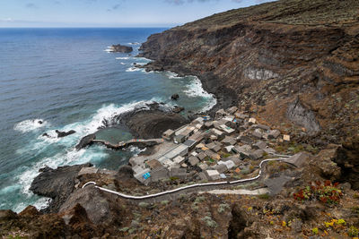 High angle view of rocks on beach against sky