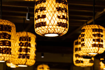 Low angle view of illuminated lights hanging from ceiling