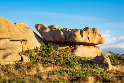 Rock formations on landscape against sky