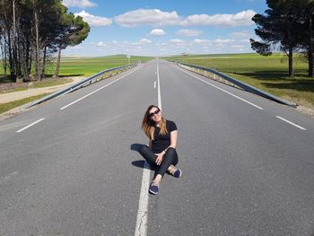 Portrait of woman sitting on road