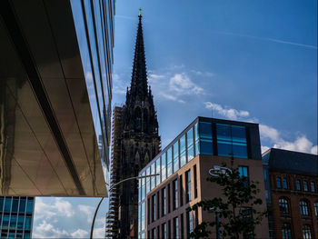 Buildings and church against sky